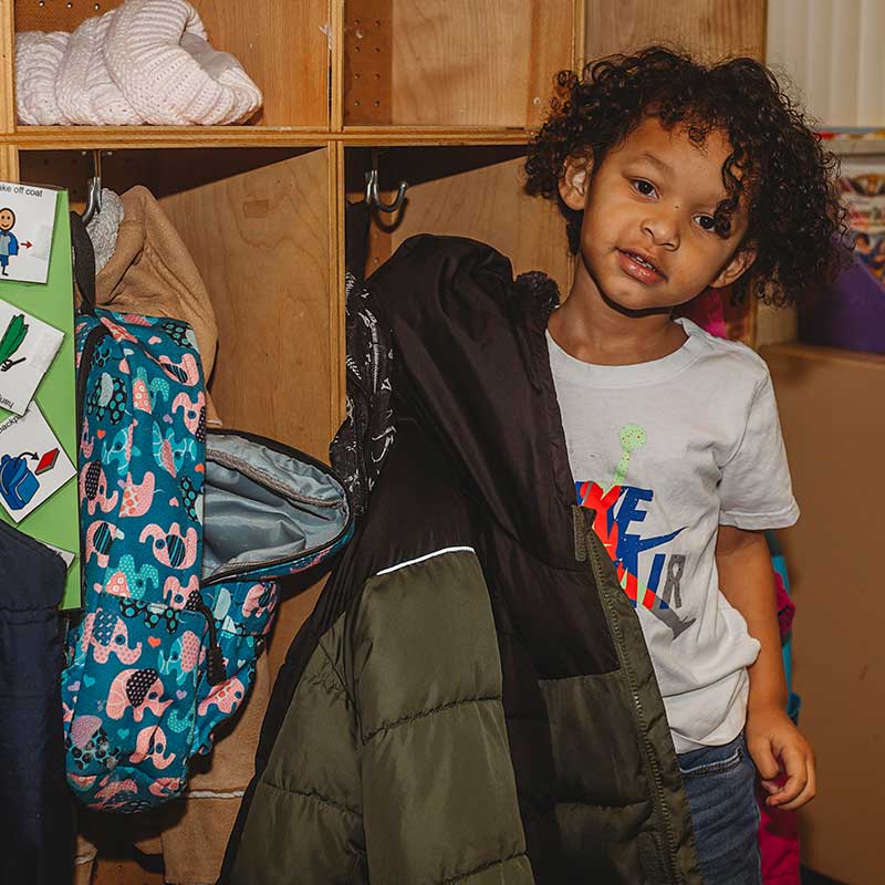 girl at locker with coat